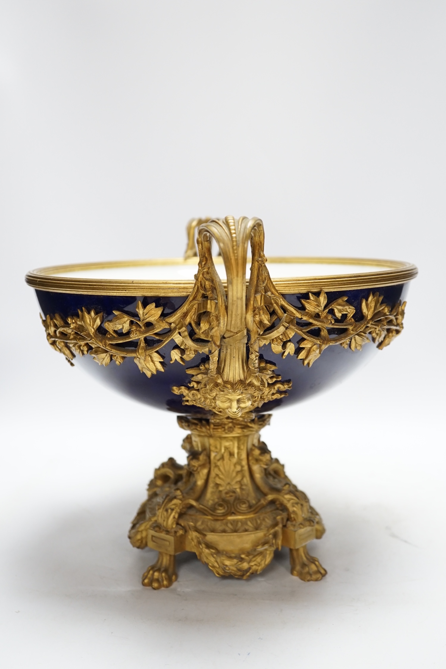 A large Louis XVI style ormolu and porcelain double handled centre dish, 27.5cm high, 31cm diameter